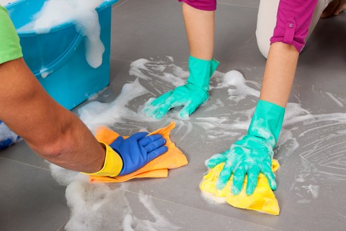 Cleaner wearing PPE while performing a safe carpet cleaning task